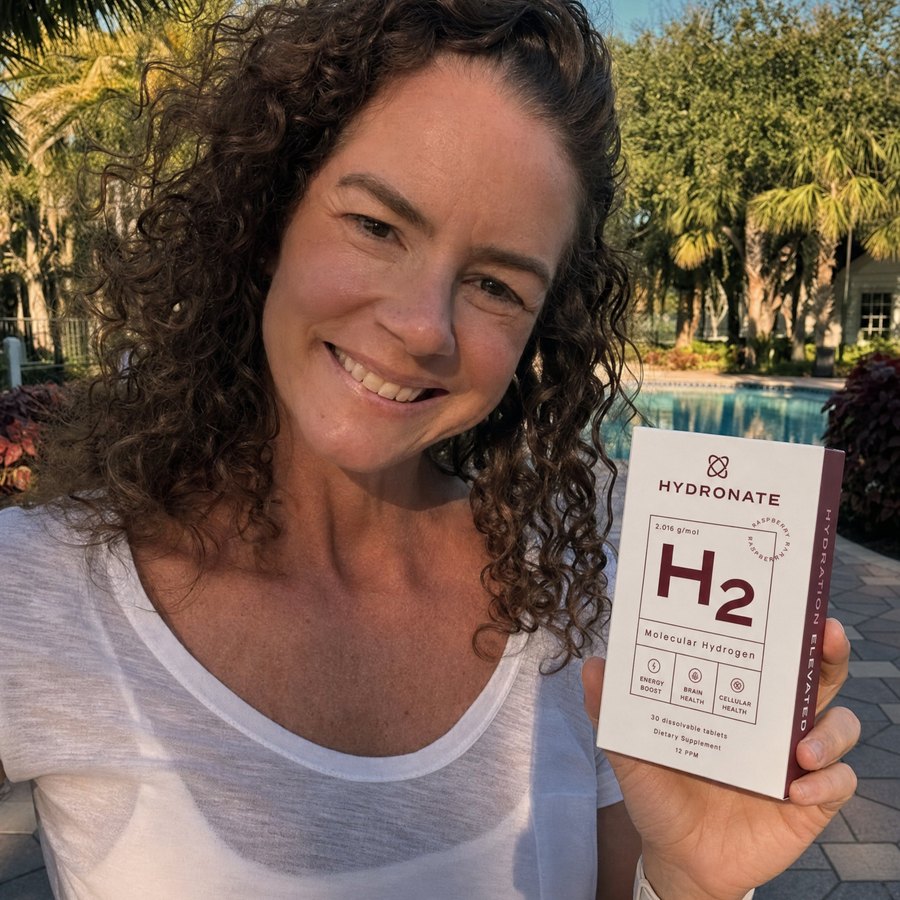 Customer holding a Hydronate H2 box outdoors by a pool.