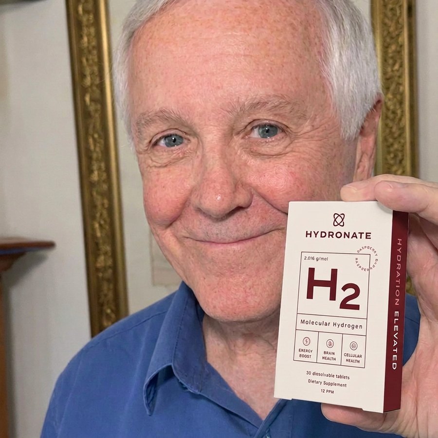 Customer holding a Hydronate H2 box in his living room.